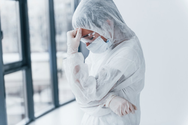 feeling bad tired and depressed portrait of female doctor scientist in lab coat defensive eyewear and mask 146671 7509